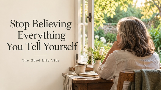 Stop Believing Everything You Tell Yourself — The Good Life Vibe, with a woman reflecting beside a sunlit window