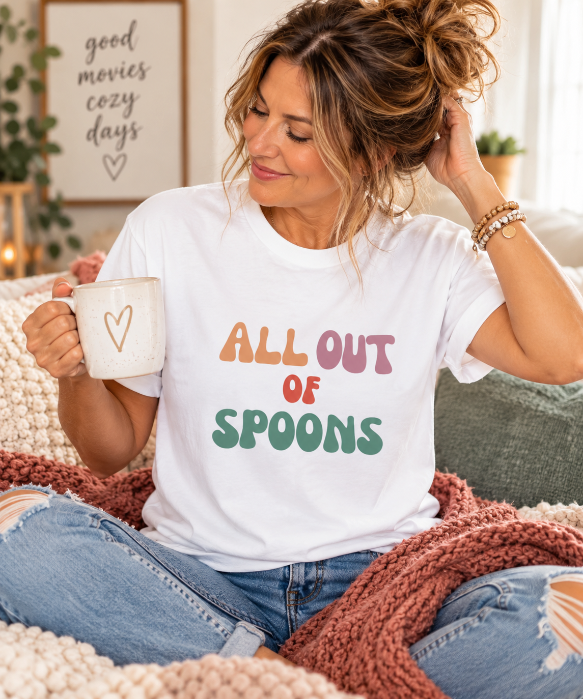 Cozy lifestyle mockup of white All Out of Spoons T-shirt with retro pastel lettering